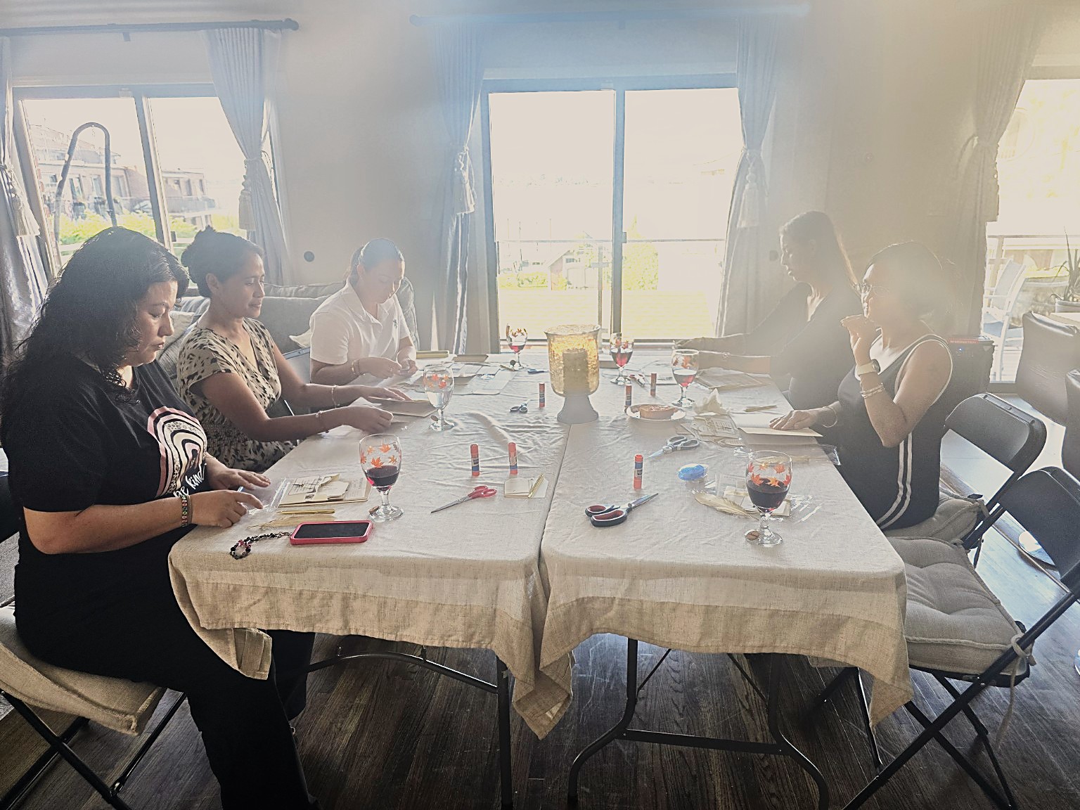 Women actively creating around the table at a My Craft Studio journaling gathering
